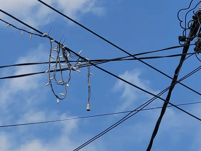 Foto Situaţie tragicomică, la Brebeni: Primăria a instalat, în 2022, ghirlande luminoase deasupra străzilor din localitate şi nu le-a mai dat jos niciodată (FOTO)